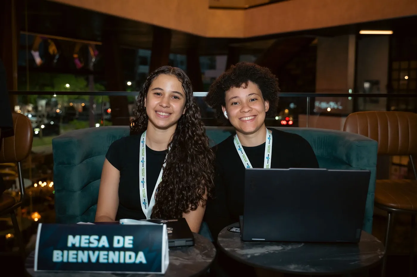 Dos voluntarias atienden la mesa de bienvenida de un evento de Fundación Enlata